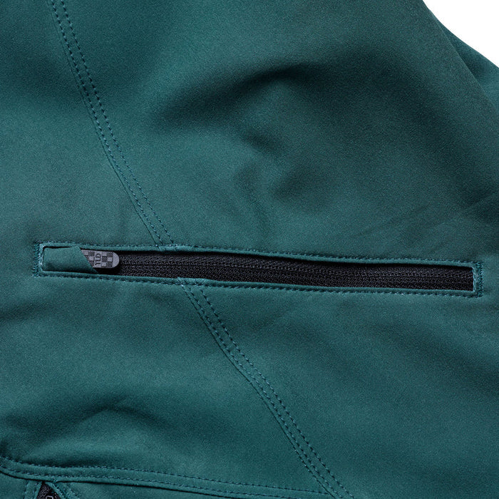 Close-up of a teal jacket with a zipper detail on a white background