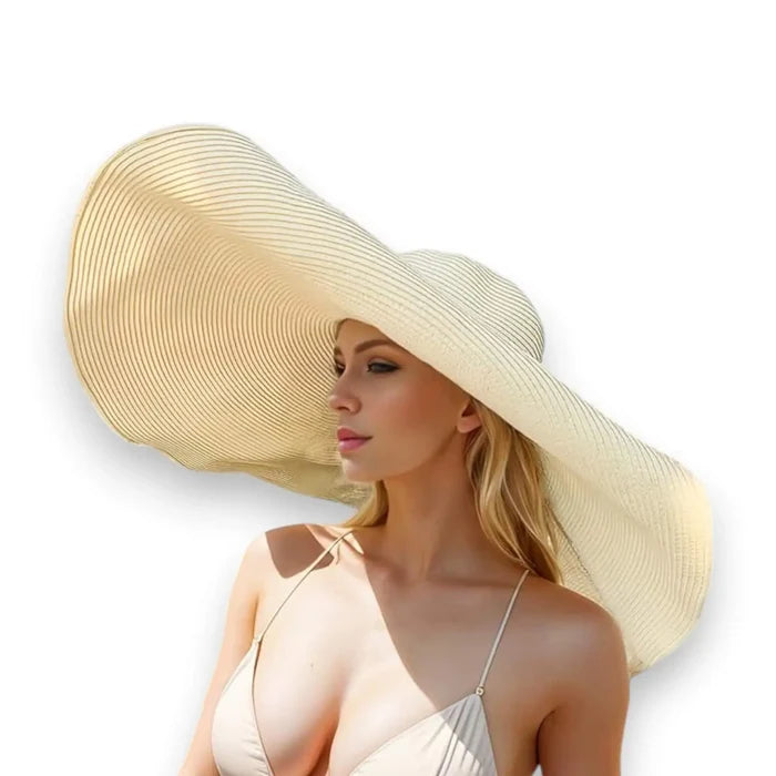 woman wearing the beige Women’s Oversized Brim Straw Sun Hat with dramatic 10-inch asymmetrical brim and woven straw beach style