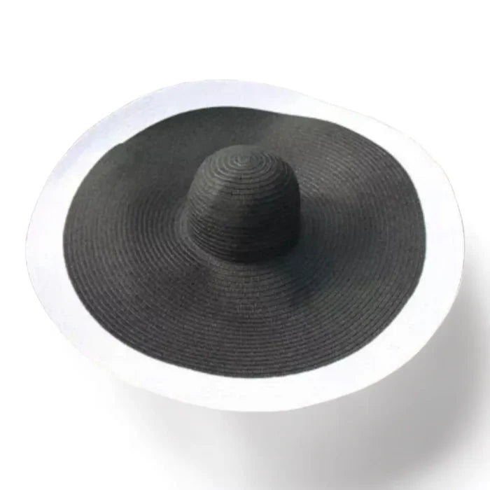 black with white trim Women’s Oversized Brim Straw Sun Hat with dramatic 10-inch asymmetrical brim and woven straw beach style